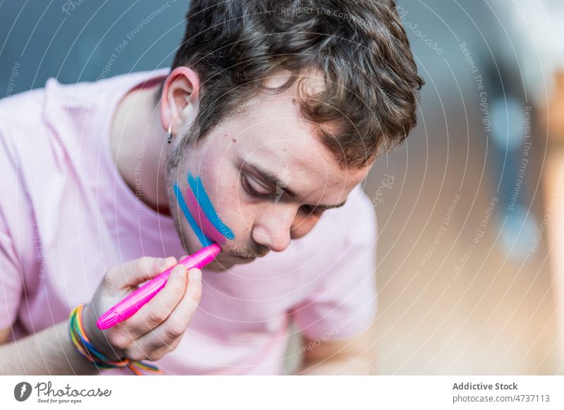 Man drawing transgender flag on cheek man symbol identity unconventional respect freedom human rights activism equal alternative stripe colorful creative