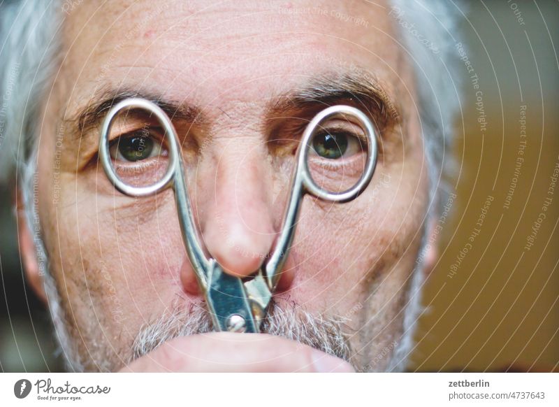 Portrait with scissors Eyes Facial hair considern adult Face Head Man Nose portrait skepticism look at Observe Looking view see peep peek Caught Surprise