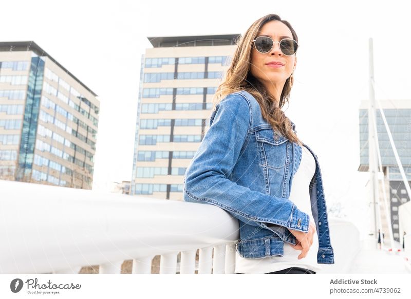Stylish woman with sunglasses in city street style outfit trendy urban fashion feminine appearance apparel jacket town garment lady wear attractive attire