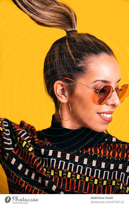 Trendy woman with ponytail in studio fashion model style smile trendy vivid sunglasses vibrant female ornament outfit cheerful accessory bright happy creative