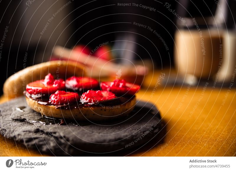 Delicious sweet bagel with strawberry on stone tray raspberry slice dessert chocolate slate plate homemade yummy tasty delicious portion palatable appetizing