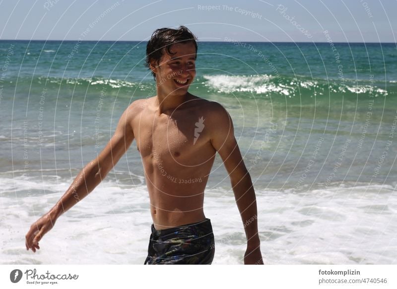 tanned laughing boy by the sea bathe Ocean Swimming & Bathing Beach vacation Water Vacation & Travel Body Wet be afloat Waves Summer Summer vacation bathing fun