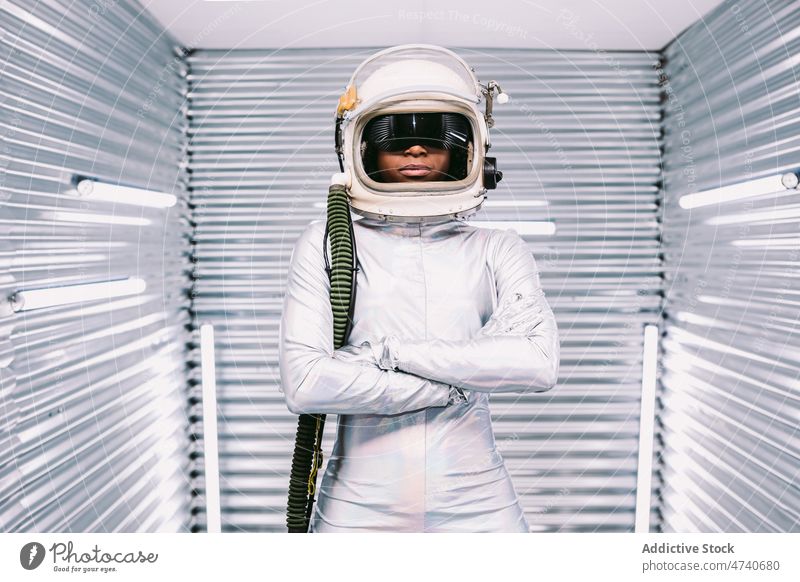 Anonymous black astronaut in light spaceship woman spacesuit helmet cosmonaut costume mission uniform modern safety african american lady confident creative