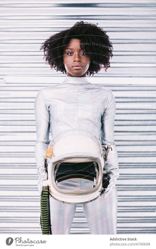 Black woman in astronaut costume spacesuit helmet spaceship cosmonaut mission uniform modern safety african american black light lady confident creative