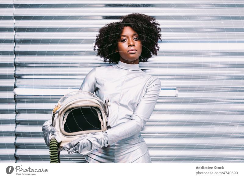 Black woman in astronaut costume spacesuit helmet spaceship cosmonaut mission uniform modern safety african american black light lady confident creative