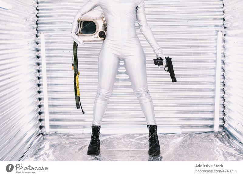 Anonymous black cosmonaut with gun in spaceship woman spacesuit astronaut weapon dangerous costume courage mission uniform modern safety african american
