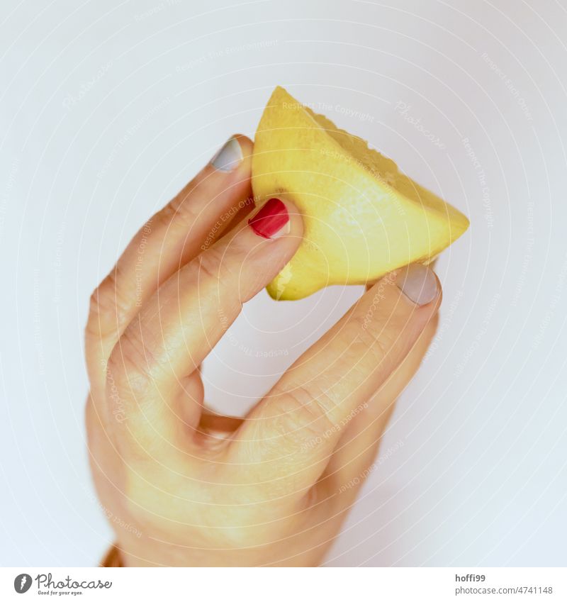 half a lemon in a hand with fingernails painted in different colors Lemon Citrus fruits Fresh Yellow Fruit Sour Vitamin C Lemon yellow painted fingernails