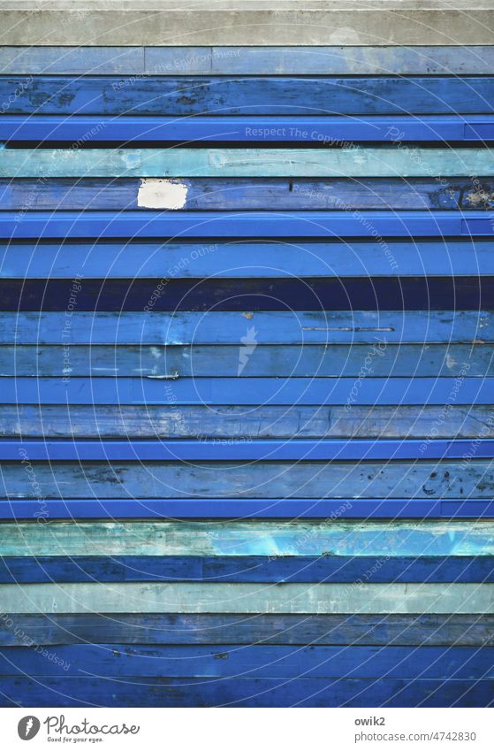 obstructionists Stack slabs Many about each other Consecutively Lie stacked Blue Stripe lines Abstract Deserted Structures and shapes Colour photo Exterior shot