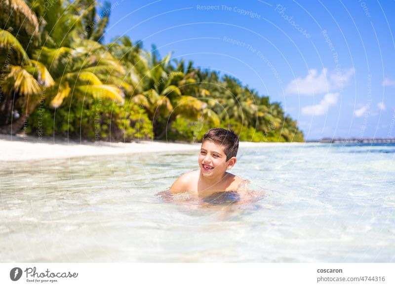 Little kid inside the water on a tropical beach baby beautiful blue blue sky boy caribbean child coast coastline cute destination exotic holiday idyllic infant