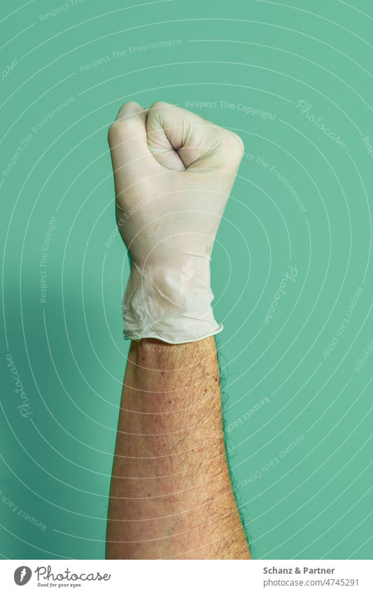 Fist with rubber glove against monochrome background Arm Business Gloves Close-up colored background Copy Space price detail Thumb Unicoloured Fingers