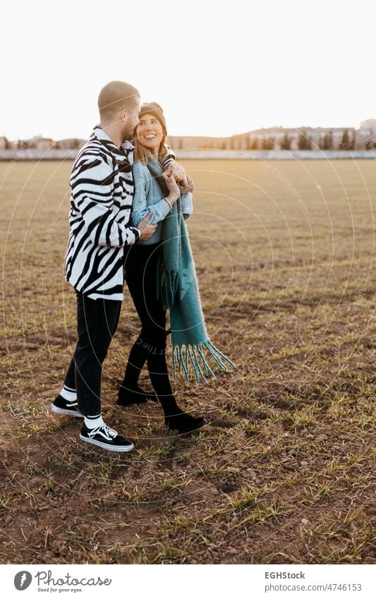 Couple enjoying a day in the field embraced. Boyfriend and girlfriend in love hug hugging couple countryside embracing journey weekend people man woman adult