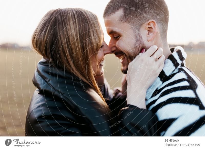 Close up couple nose kissing in the countryside embraced. Boyfriend and girlfriend in love close up hugging two people embracing journey weekend man woman adult