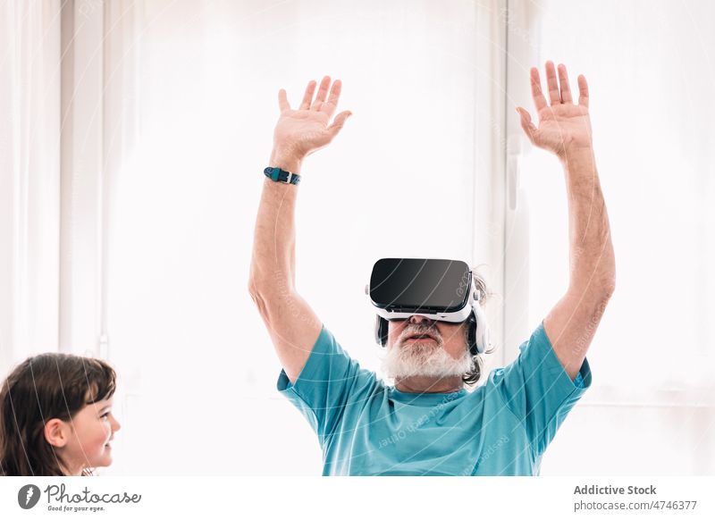 Grandfather in VR goggles near girl grandfather vr headset explore cyberspace futuristic virtual reality immerse simulator modern elderly pensioner male