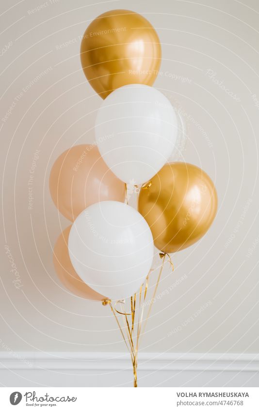 Festive balloons in gold, pink and white in a bouquet holiday anniversary birthday celebrate festive helium party ribbon surprise air ballon fun celebration