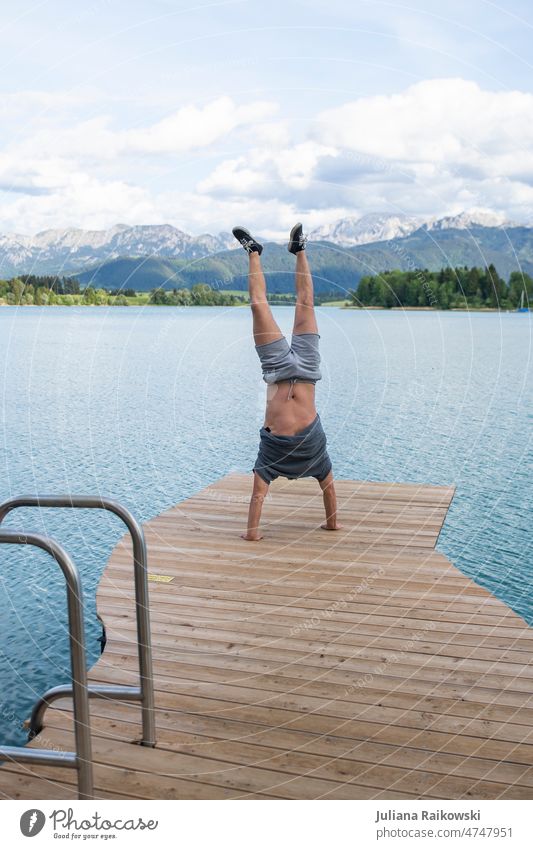 Man does handstand in front of breathtaking scenery of alps Handstand Alps Human being Colour photo Adults 1 Exterior shot Masculine Day Young man 18 - 30 years