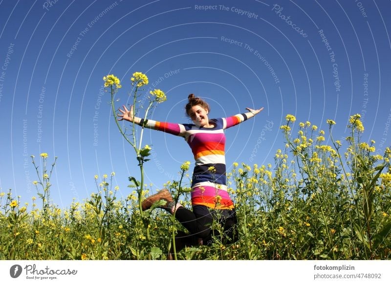 young woman jumping in a rape field in bloom Joy Jump Hop Woman Young woman Girl Happy pleased Free Joie de vivre (Vitality) Happiness Movement Nature Feminine