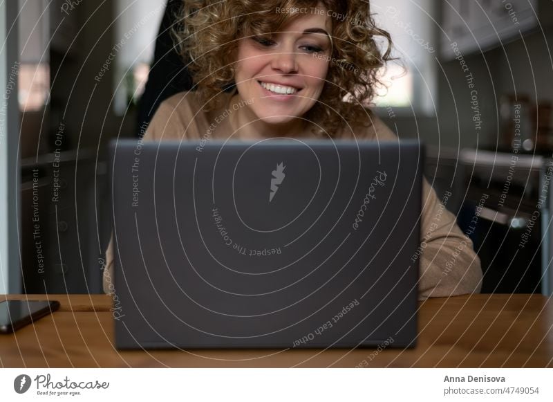 Woman and laptop woman home working computer technology sitting using laptop job looking business indoors focused desk businesswoman joy house smiling kitchen