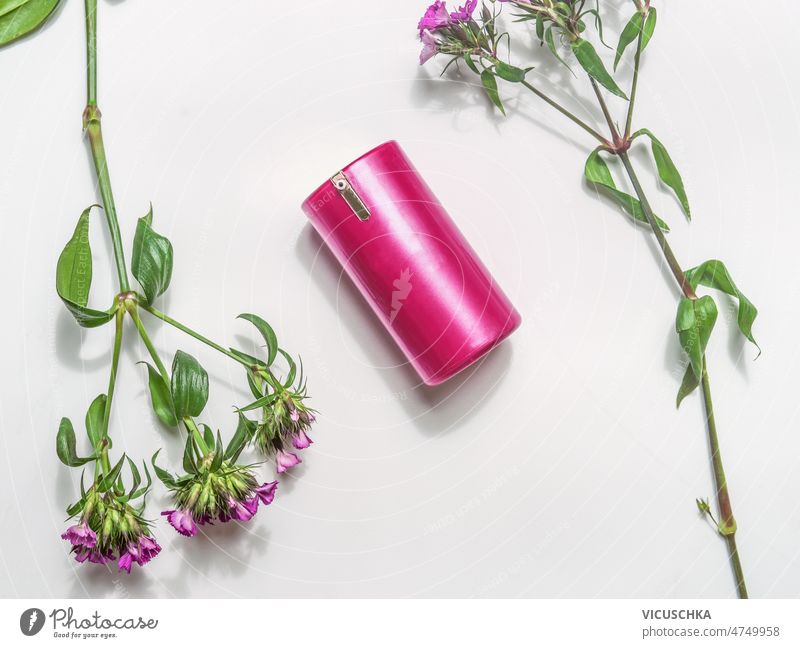 Pink cosmetic product on white background with pink flowers. top view natural cosmetic health green bottle design spa healthy copy space beauty