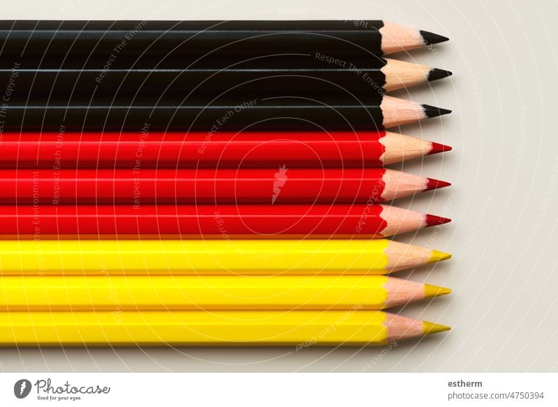 Top view of Germany flag made with black, red and yellow colored pencils with copy space german flag world state europe abstract sign symbol national