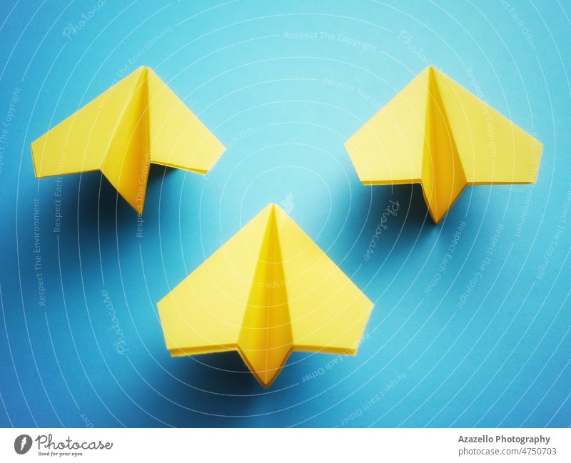 Group of three yellow paper jets on blue background. aid aircraft alliance bomber chernobyl colors concept conflict dombass eu europe fighter fighter jet flag