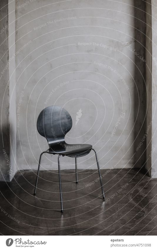 Empty chair in front of a concrete wall in a photostudio empty empty chair floor grey missing no person photography shadows vertical Deserted Wall (building)