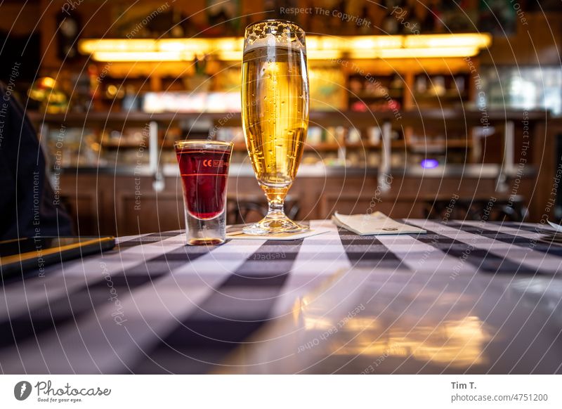 a cherry liqueur and a beer on the pub table with tablecloth Berlin Prenzlauer Berg corner pub Roadhouse Beer Beer glass Liquer Old building Town Capital city