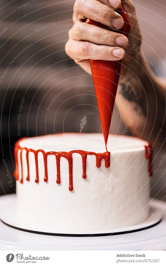 Crop baker decorating yummy cake woman decorate glaze icing squeeze pastry bag plate spin bakery female work dessert baked sweet prepare delicious tasty cream