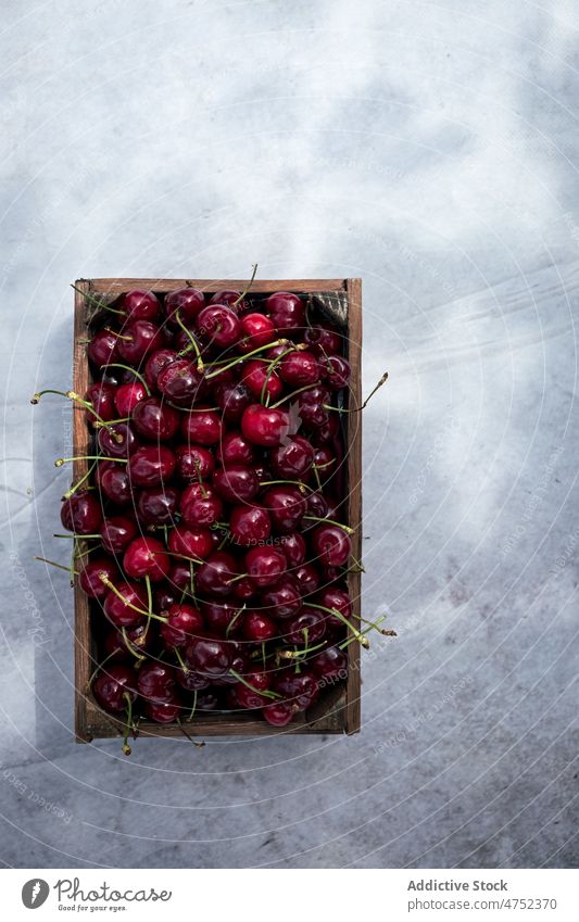 Wooden box of ripe cherries cherry fresh berry summer table natural food bunch organic fruit vitamin lumber composition wooden raw crate sweet timber product