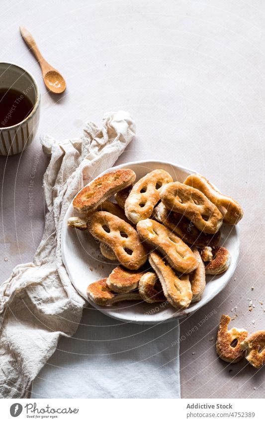 Bowl with pretzels during breakfast morning pastry table coffee tea napkin bowl fresh cup food tasty beverage dessert serve sweet crunch teatime bunch baked