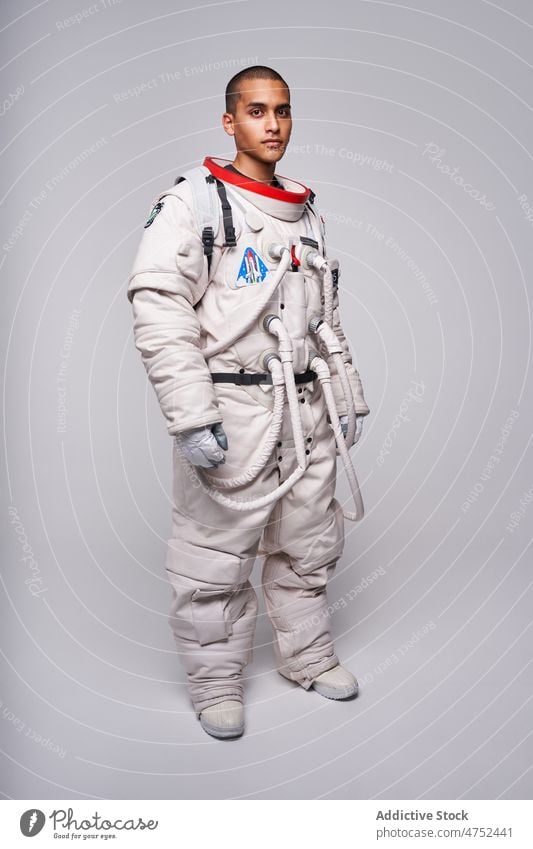 Brave ethnic cosmonaut in spacesuit in studio ready for flight man astronaut universe mission latin astronomy discovery uniform male investigate hispanic