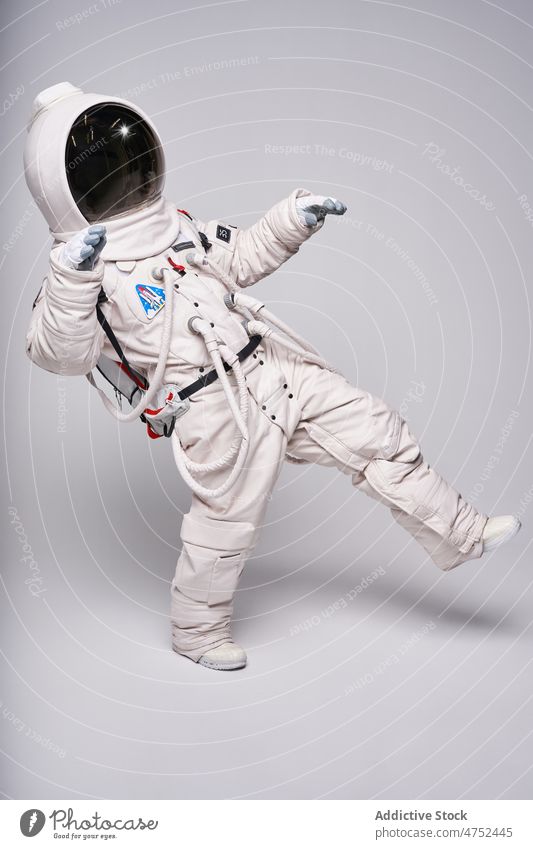 Astronaut in spacesuit pretending flying in weightlessness astronaut fantasy zero gravity helmet balance motion concept astronomy imagination cosmos visor move