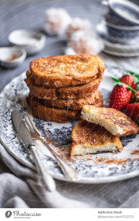 French toasts with strawberries french toast strawberry plate breakfast morning silverware serve food table sweet fresh yummy tasty dessert delicious ingredient