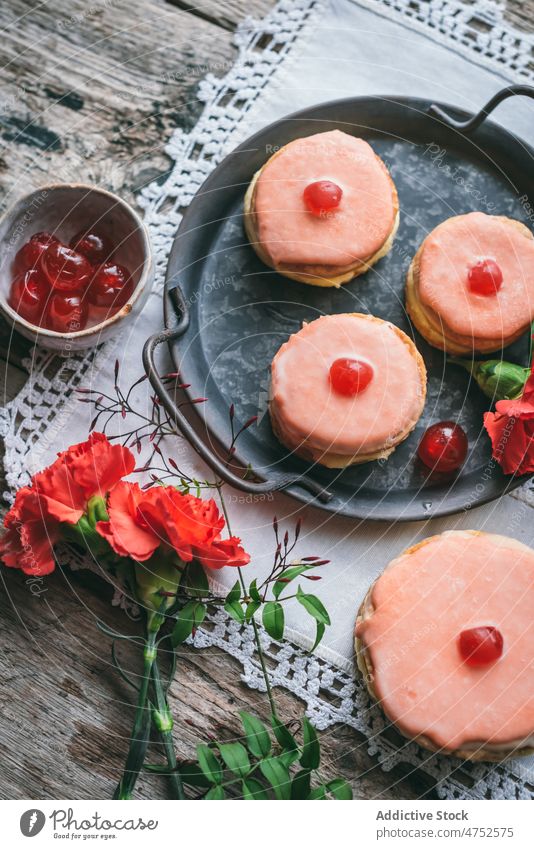 Yummy cakes near red carnations dessert jelly icing flower confectionery sweet flavor table tasty serve tray portion delicious food pastry appetizing fresh