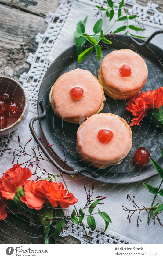 Yummy cakes near red carnations dessert jelly icing flower confectionery sweet flavor table tasty serve tray portion delicious food pastry appetizing fresh