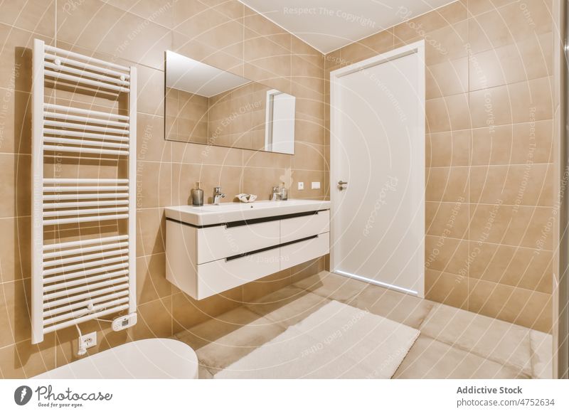 Modern bathroom with beige tiled walls interior style minimal sink modern design ceramic apartment new sanitary clean washroom hygiene contemporary estate tidy