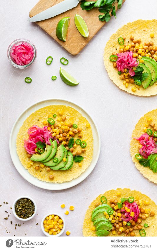 Fresh tortillas with various toppings taco mexican filling avocado chickpea traditional food kitchen culinary lime slice ingredient nutrition tasty delicious