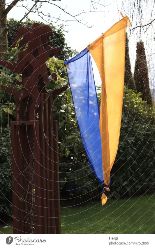 Solidarity - Ukrainian flag, knotted at the bottom, in a garden Ukraine Flag Garden Politics and state War Peace Symbols and metaphors Peace Wish Hope Sign