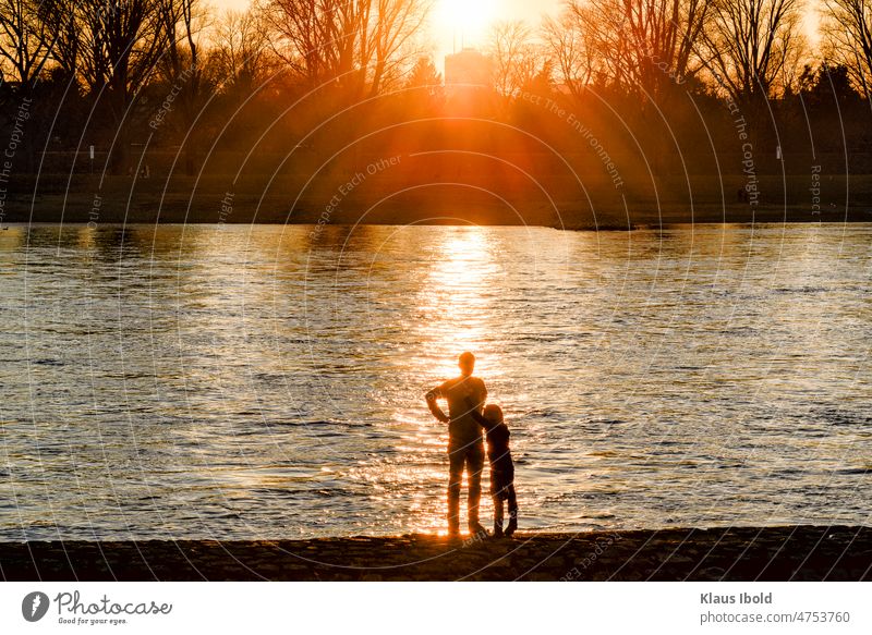 Father and daughter in front of a sunset on the Rhine near Düsseldorf Duesseldorf Landscape nature themes Sunset Couple RomanticIdylle romantic idyllic. beauty