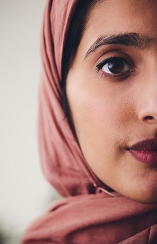 Cropped portrait of young Muslim woman wearing hijab looking towards camera with confident expression muslim middle eastern crop hajab one pride