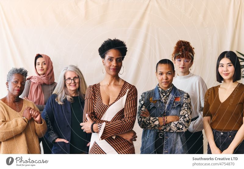 International Women's Day portrait of confident multiethnic mixed age range women looking towards camera solidarity diverse female group females