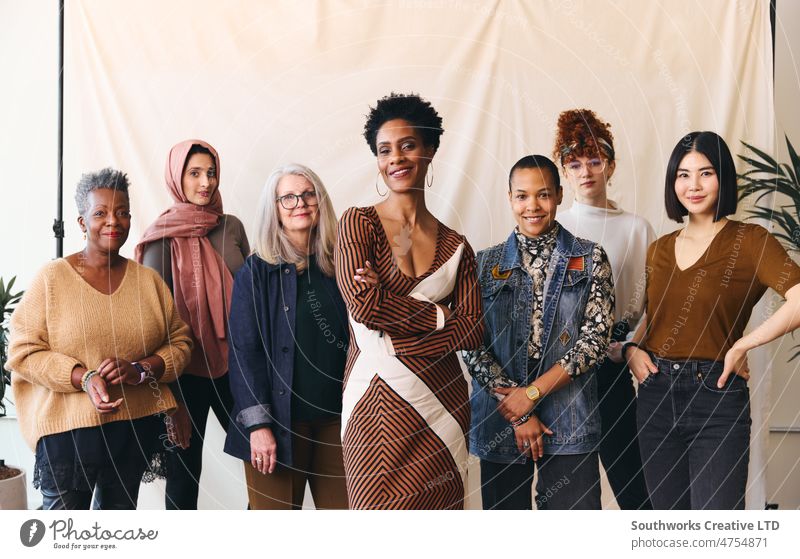 International Women's Day portrait of multiethnic mixed age range women looking confidently towards camera and smiling solidarity diverse female smile pride