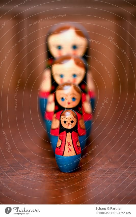 four russian matryoshkas on a wooden table Matryoshka Babushka Russia Russian Game pieces Toys Wooden toy Tradition Souvenir