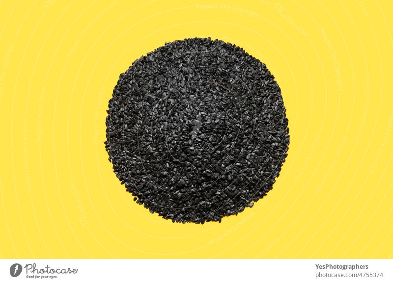 Black sunflower seeds top view. Pile of sunflower seeds isolated on a yellow background above agriculture autumn black bright bunch cereal close-up color crisis