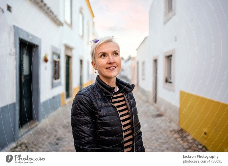 Portrait of blond modern woman in urban settings portrait city middle age faro historical relaxing standing downtown building happiness algarve destination