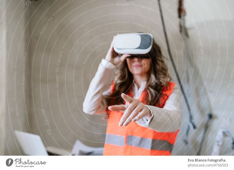 architect woman in construction site using virtual reality goggles working on VR blueprints inspector forewoman technology kitchen checking home laptop