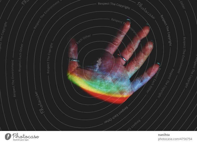 Detail of human hands illuminated by colorful lights rainbow otherwordly future scan dark darkness mystery part delicate spectrum physics prism creativity