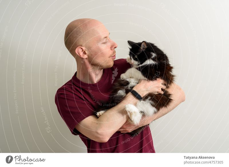 Hairless man holding his cat male pet stroke hand love friendship togetherness mental hairless recovery furry animal lifestyle contact adult domestic cat indoor