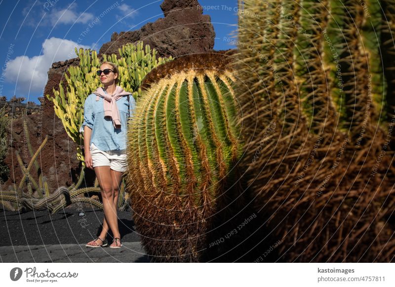 Female tourist sightseeing at tropical cactus garden in Guatiza village, Lanzarote, Canary Islands, Spain. landmark spain female woman green nature tourism