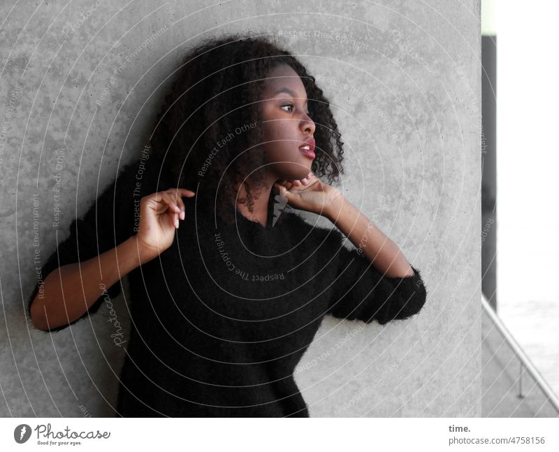 Woman with arms raised portrait Profile Curl Sweater Dark-haired Wall (barrier) Arm hands Stand Wall (building) Earnest Forward Feminine Long-haired