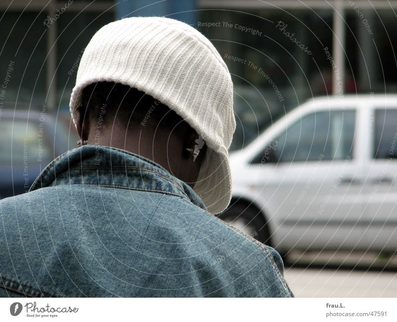 hatched Earring Man Transport Bus stop Cap Town Jeans jacket Gray Rope Reading Youth (Young adults) Clothing Human being Street Wait Back Car Blue Neck Fashion